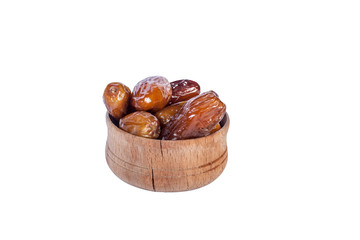 Wooden bowl of dried dates isolated on white background