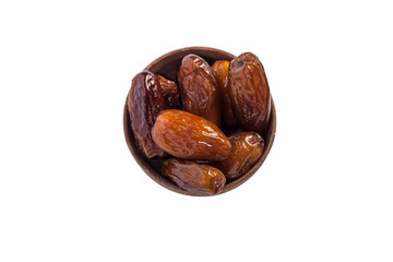 Wooden bowl of dried dates isolated on white background