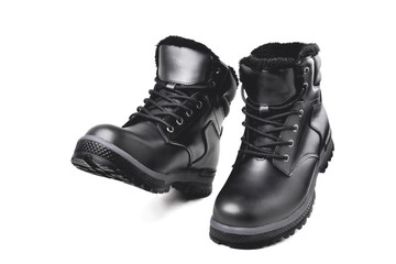 Winter men’s black leather boots on a white background, hiking shoes, practical off-road shoes, close-up