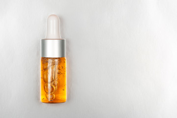 Bottle of beauty oil on silver luxury background