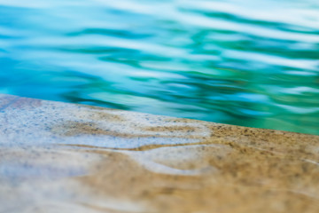 Ripples in the turquoise pool water. Close-up, background