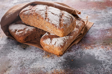 Freshly baked sourdough rye flour bread with sunflower and pumpkin seeds on a brown napkin. Copy space