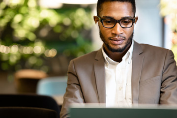Portrait of black guy using pc listening to music