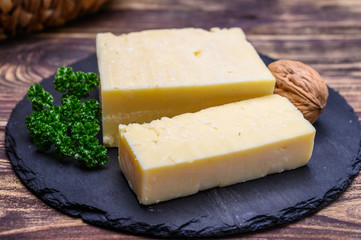 Fototapeta na wymiar British hard cheeses made from cow milk matured cheddar from Somerset