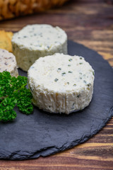 Spread cream cheese with herbs, garlic, chives and spices close up