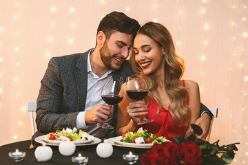 Romantic couple in love having date in restaurant, celebrating anniversary