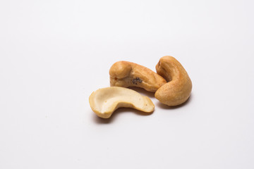 Cashew nuts on the white background. Healthy vegetarian snack. Close-up photo. Space for your text.