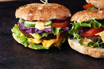 Tasty fresh meat burgers with salad and cheese and french fries. Homemade angus burger.