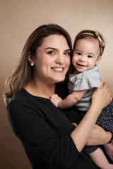 Mom holding small baby girl