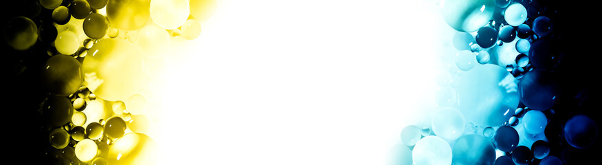 Creative abstraction frame of a colorful circles of different sizes with backlight and gradient with white isolated free space in center.