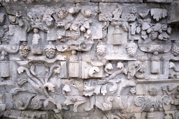 Fragment of stone bas-relief on the wall of the building.