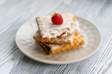 food photography in a high key. Waffles and strawberries. Desserts with berries.