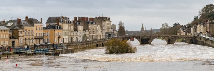 Fototapeta na wymiar Laval, beautiful french city, panorama of the river and typical houses in the ancient center, downtown under the floods, the river in flood