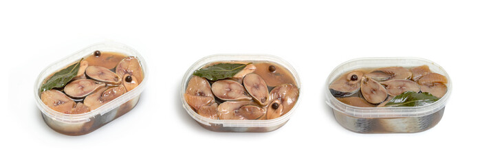 Sliced fish with spices in a plastic jar on a white background.
