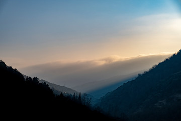 Misty clouds at sunrise in the mountains