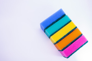 Sponges for washing dishes, on a white background, isolated. Colorful multi-colored as rainbow sponges lay one each other. Copy space