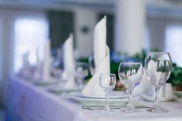 wedding reception. tables with plates, wineglass and napkins.