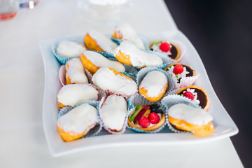 cookies covered with cream and cookies decorated with fruits and