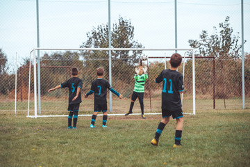 Young children players match on soccer field