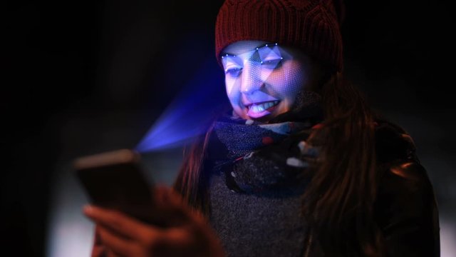 Smartphone using facial recognition system to unlock. A woman face is being scanned as a security measure. Face detection points. Perfect to illustrate: security system, futuristic technology.