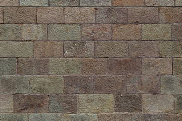 Brick wall texture. Old brickwork with multicolor bricks in tints of pink, yellow, green