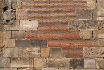 Old brick wall background. Ancient brickwork combined with big stone blocks