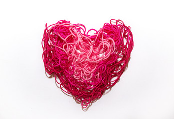Pink heart from threads on a white background Valentine's Day banner