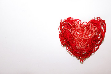 Red heart from threads on a white background Valentine's Day banner Copy-space