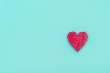 Wooden heart over pastel green background. Valentine's Day Background