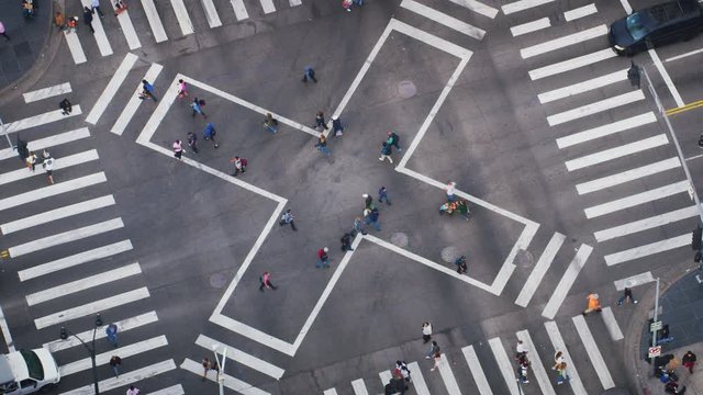 Aerial view of a crosswalk full of people. Pedestrians crossing a major avenue. United States. Shot on Red Weapon 8K