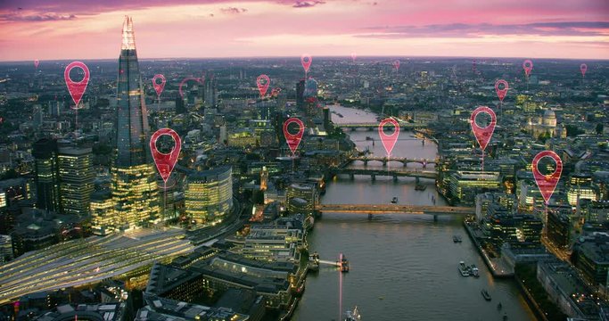 Aerial smart city. Localization icons in a connected futuristic city. Technology concept, data communication, artificial intelligence, internet of things. London skyline. Shot on Red Weapon 8K.