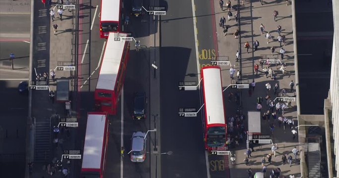 Aerial view of commuters walking near London Bridge. Facial recognition interface showing personal data for each person. Surveillance concept. Artificial intelligence. Shot on Red Weapon 8K.