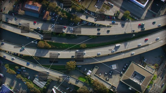 Surveillance system. Aerial view of traffic on a major highway. Text boxes containing drivers and vehicles information. Future transportation. Artificial intelligence. Computer vision.