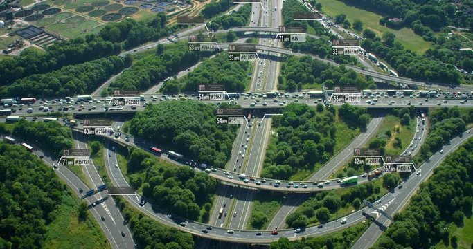 Surveillance system. Aerial view of traffic on a major highway. Connected network. Identity and speed Control System. Future transportation. Artificial intelligence. Shot on Red Weapon 8K.