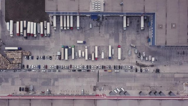Cargo logistic terminal with a lot of trucks. Aerial drone top down 4k video.