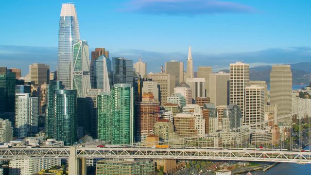  San Francisco Financial District aerial view. Famous skyscrapers and Bay bridge full of traffic. California, United States. Shot on Red weapon 8K.