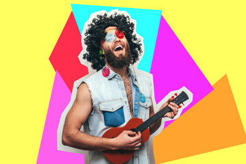 Friendly bearded young male hippie with curly hair in stylish sunglasses isolated on colorful...
