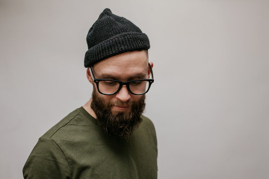 Handsome hipster guy with beard wearing blank casual beanie. Mockup for print