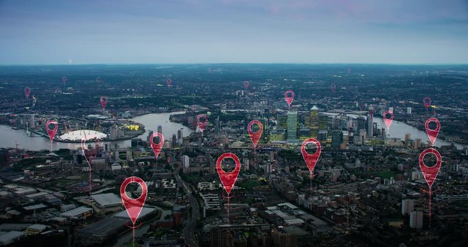 Aerial smart city. Localization icons in a connected futuristic city.  Technology concept, data communication, artificial intelligence, internet of things. London skyline. Shot on Red Weapon 8K.