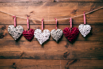 Various wicker decorative hearts hanging on a rope