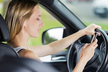 Fototapeta na wymiar woman checking her phone while driving