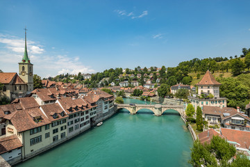 Fototapeta na wymiar Bern, Switzerland - July 26, 2019: Panoramic view from one of the bridges. . Aare river at sunny summer day