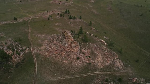 Baikal Valley spirits,Tazheran steppe, stone cliffs on the road. Aerial Summer