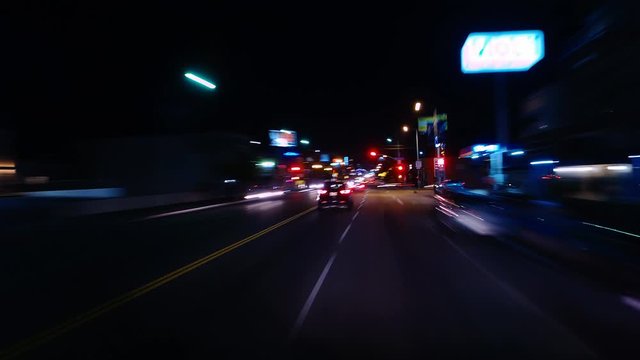 Hyperlapsed view from a car at night. POV. Hollywood, Walk of Fame. Los Angeles, United States. Perfect to represent concepts as autonomous driving, futuristic cityscape, city life, etc.  