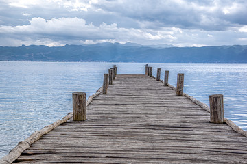 Close up of one old wooden pier. Ohrid Lake, Spring,  North Macedonia.Concept of traditional architecture.