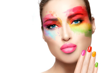 Fashion model girl with rainbow colored abstract makeup. Make-up and nail art concept. Fine art beauty portrait