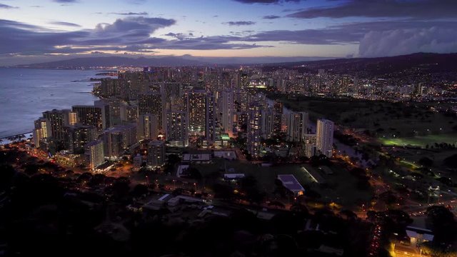 Honolulu skyline. Aerial view of Waikiki skyline, Ala Wai canal and Kapi olani Regional Park. Oahu is the third largest Hawaiian island. Hawaii, United States. Dusk.
