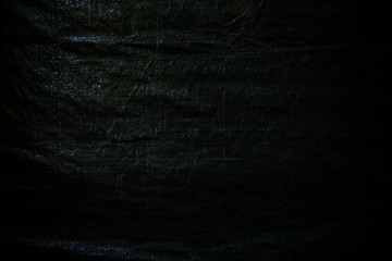 Wrinkled green tarp. Dark high resolution abstract full frame textured background.