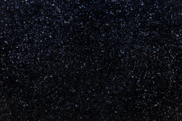 Close-up of natural granite stone. Abstract dark full frame textured background.