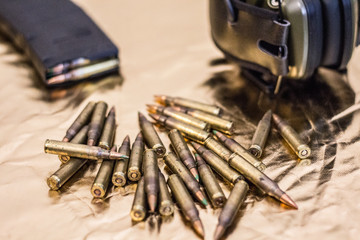 Pile of rounds next to other gun equipment